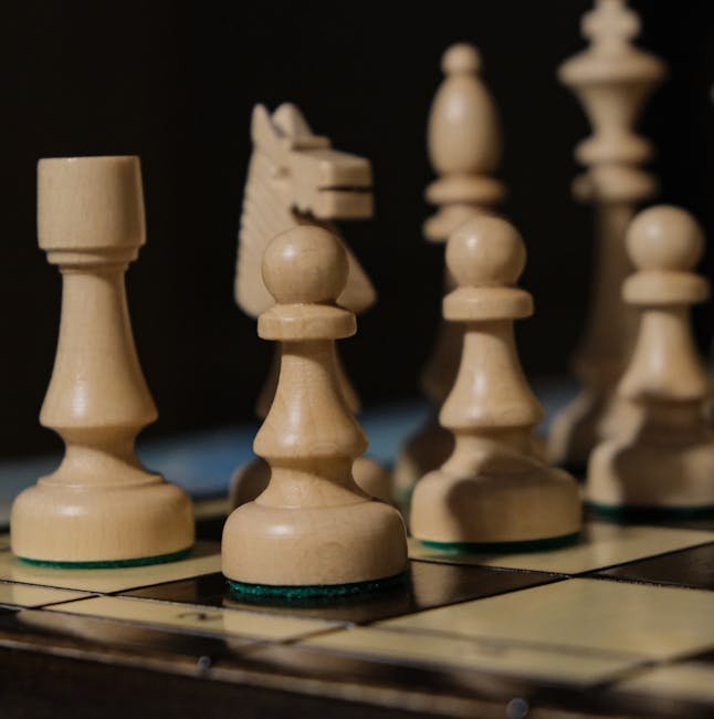 Detailed view of wooden chess pieces on a board with selective focus.